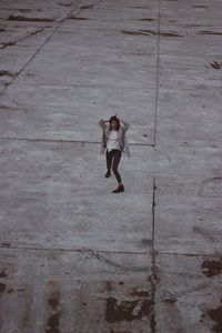 High angle view of young woman screaming on landscape