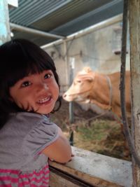 Portrait of smiling girl in stable