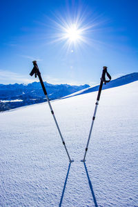 Scenic view of snow covered mountain against blue sky