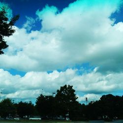 Silhouette of trees against cloudy sky