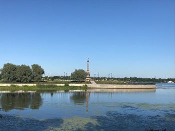 View of lake against clear blue sky