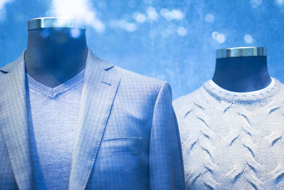 Close-up of clothes on mannequins against defocused lights