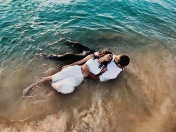 High angle view of woman relaxing in sea