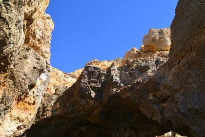 Low angle view of rock formation against sky