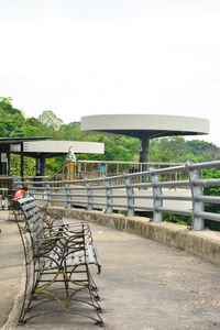 Empty footbridge against clear sky