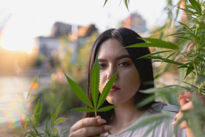 Portrait of young woman amidst plants