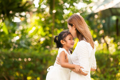 Mother and daughter at camera