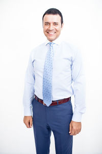 Portrait of smiling man standing against white background