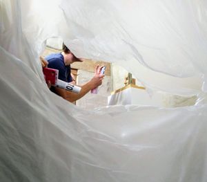 Close-up of man using mobile phone on bed