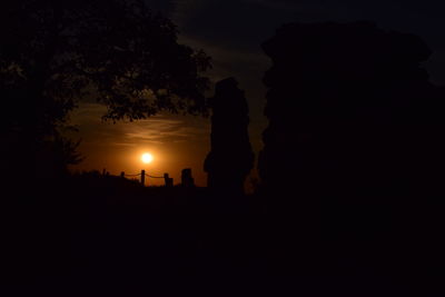 Silhouette trees against sky during sunset