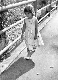 High angle view of girl standing by railing