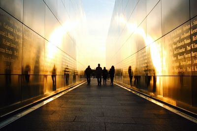 Rear view of silhouette people walking at national september 11 memorial and museum