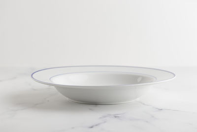 Close-up of empty bowl on white background