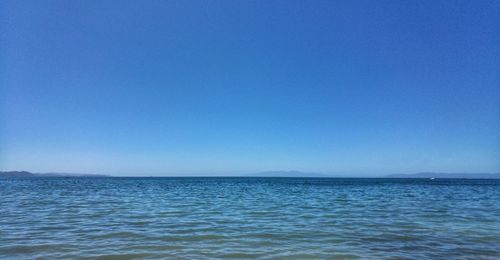 Scenic view of sea against clear blue sky