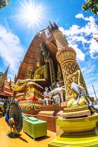 Low angle view of statue against temple against sky