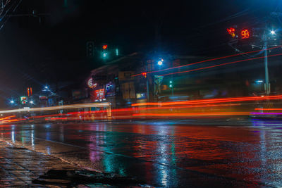 Light trails on wet street at night