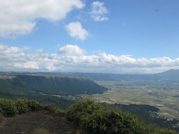 Scenic view of sea and mountains against sky