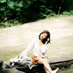 Young woman sitting on field