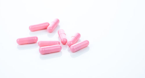 Close-up of pills over white background