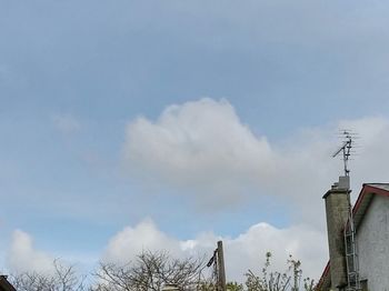 Low angle view of building against cloudy sky