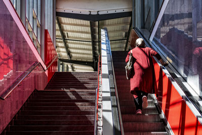 Rear view of woman walking on stairs