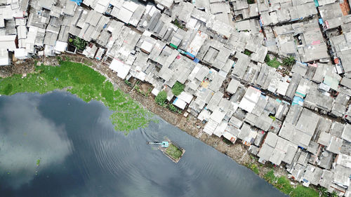 High angle view of river by buildings in city