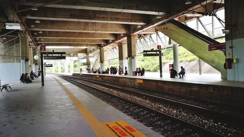 People waiting at railroad station platform