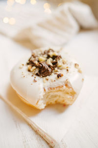 Tasty white donut with choco cream and holiday details in light background 