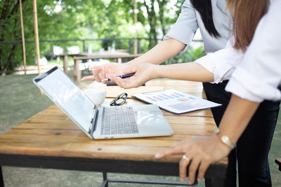 Midsection of woman working at table