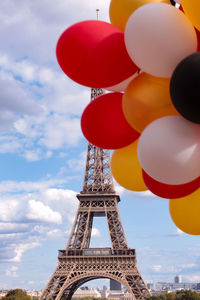 Low angle view of balloons against cloudy sky