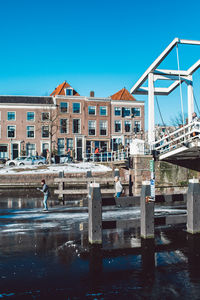 Reflection of building in water against clear blue sky