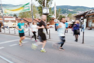 People walking on road in city