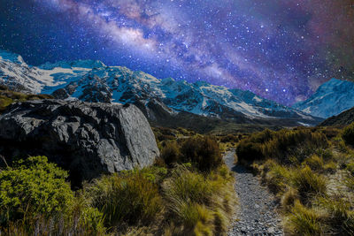 Snowcapped mountains against sky at night