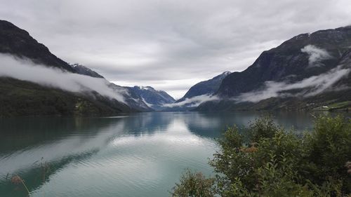 Scenic view of lake and mountains against sky