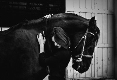 Woman standing with horse