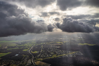 Aerial view of cityscape against cloudy sky