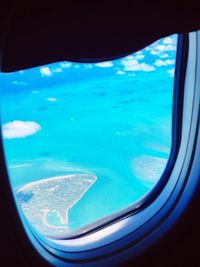 Aerial view of sea seen through airplane window