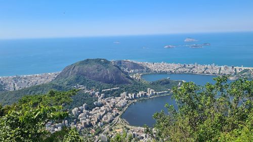 High angle view of sea and cityscape against sky