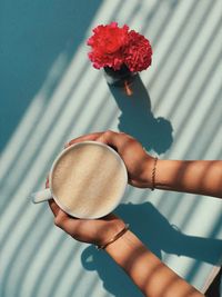 Cropped hands of woman holding coffee cup