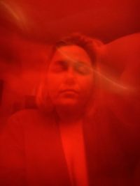 Close-up portrait of man with red eyes