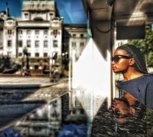Portrait of young woman standing in city