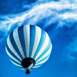 Low angle view of hot air balloon against blue sky