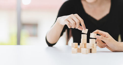 Close-up of hand holding toy on table