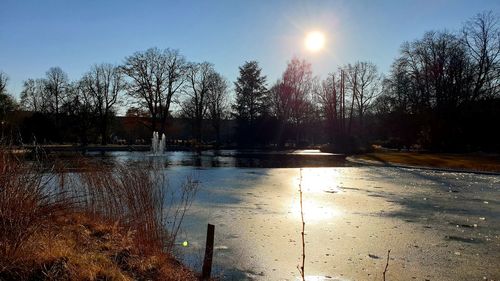 Scenic view of lake against sky during winter