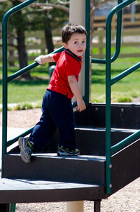 Toddler climbing up steps, making sure mom is watching