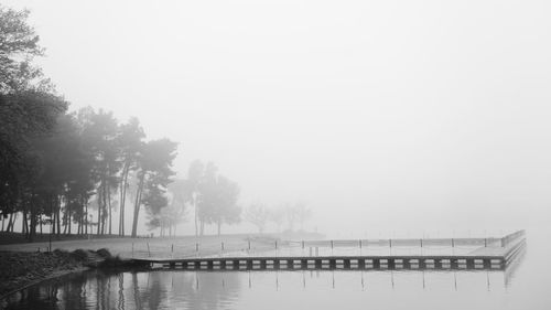 Scenic view of lake against sky during winter