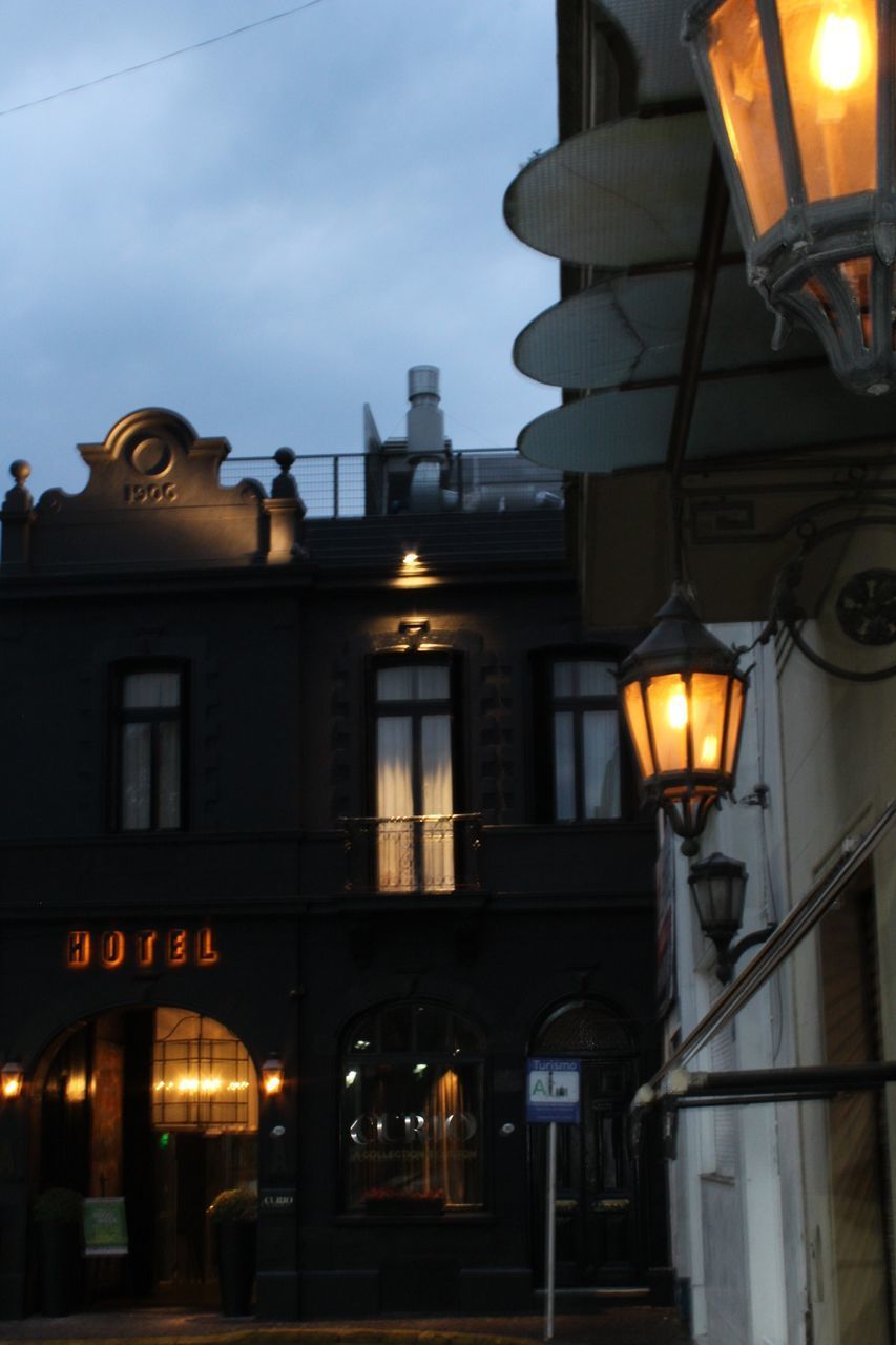 LOW ANGLE VIEW OF ILLUMINATED STREET LIGHT AGAINST SKY