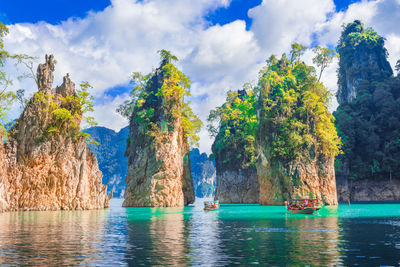 Panoramic shot of trees by sea against sky