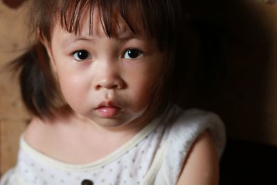 Close-up portrait of cute girl at home