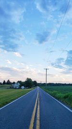 Road passing through landscape against sky